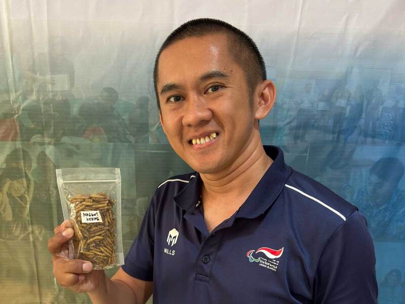 Our young entrepreneur displays containers used for his maggot-based composting business